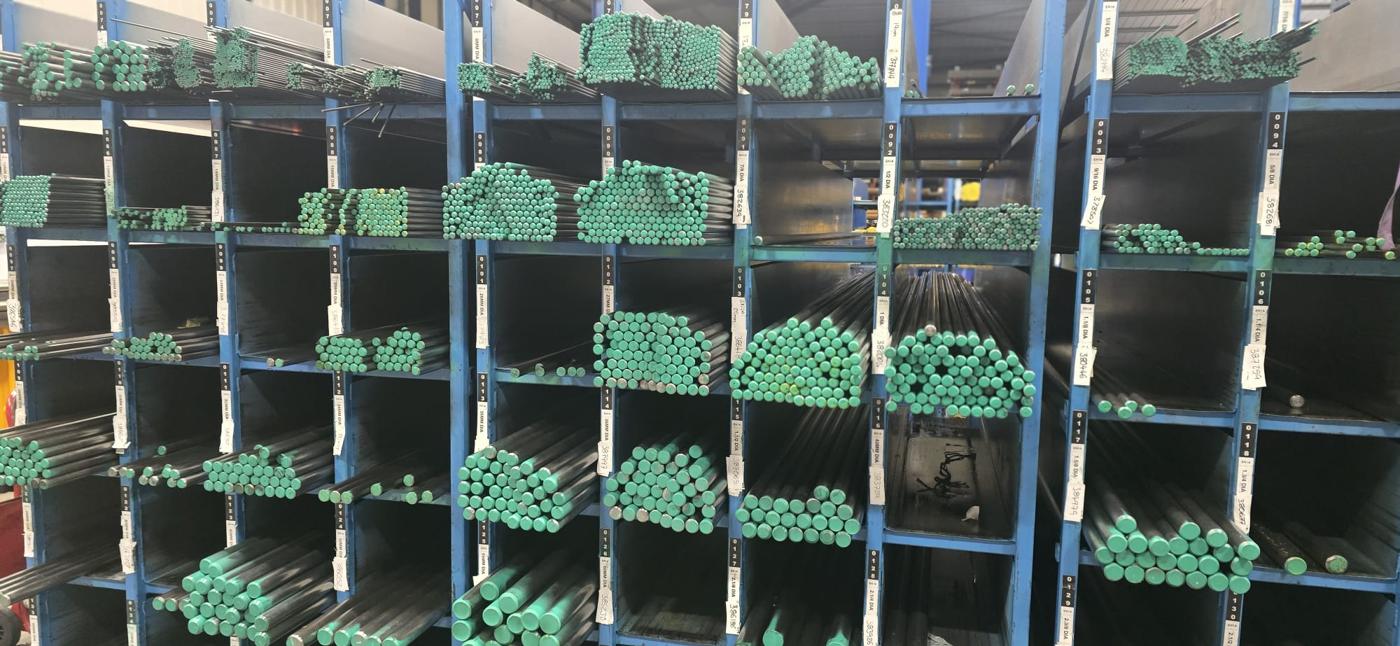 Standard non-leaded EN1A (230M07) bright round bar in the same pigeon-hole racking, ends paint-marked green, locations labelled with diameter and cast number