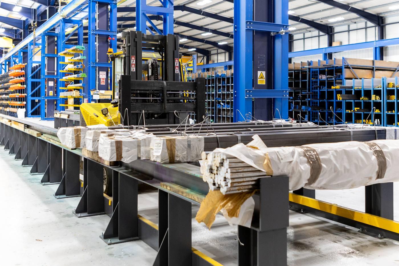 Parkside Steel despatch — wrapped bundles of bright bar on long despatch table ready for UK delivery