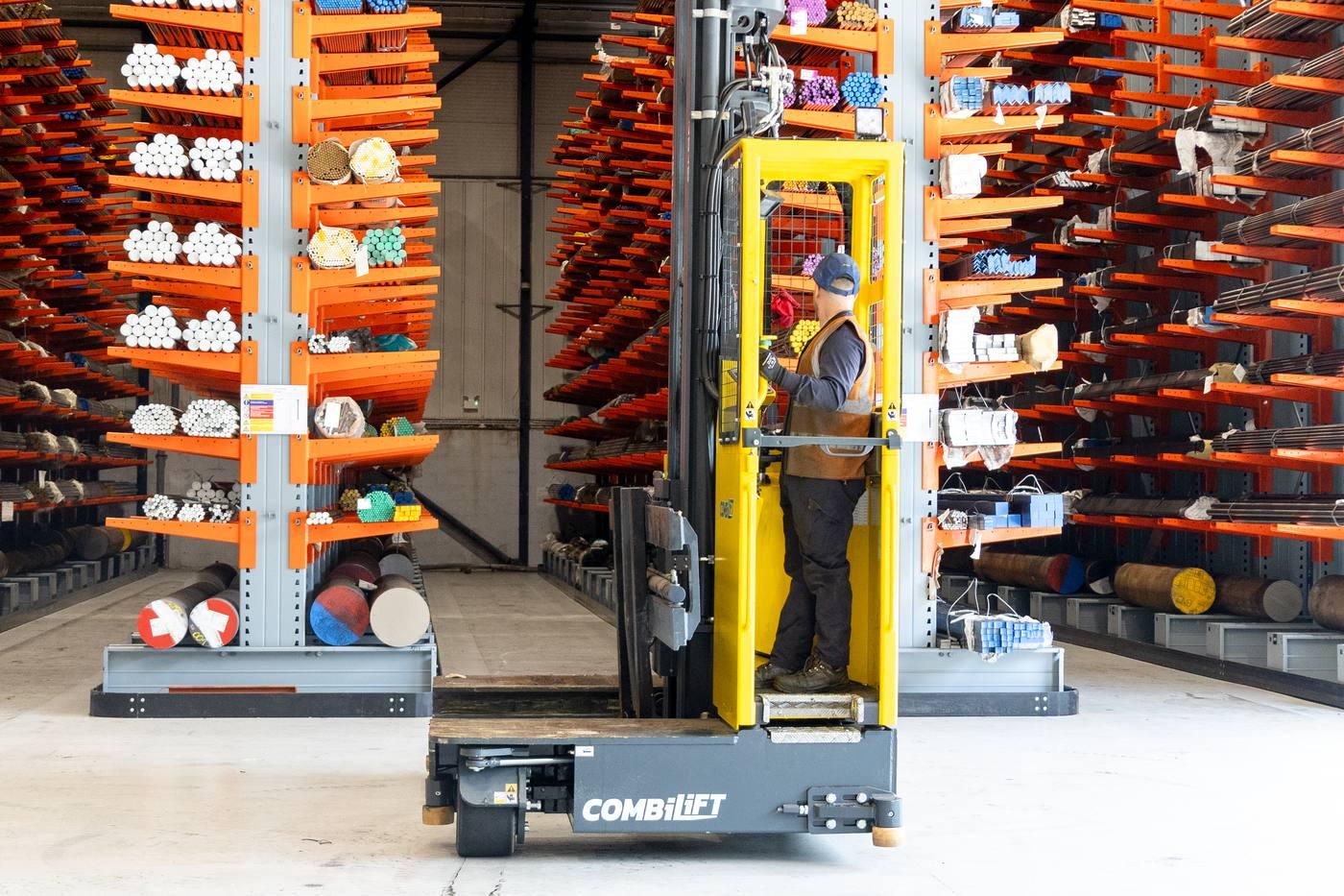 Combilift in orange racking aisle — defence and aerospace grade alloy bar stock