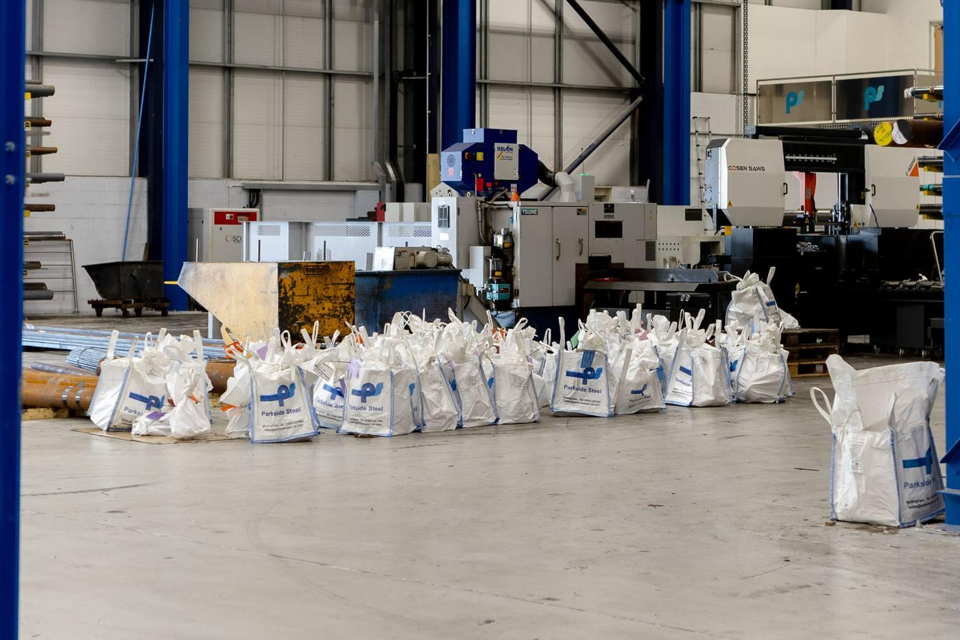 Parkside Steel branded bulk bags ready for despatch — TSUNE and COSEN saws visible behind