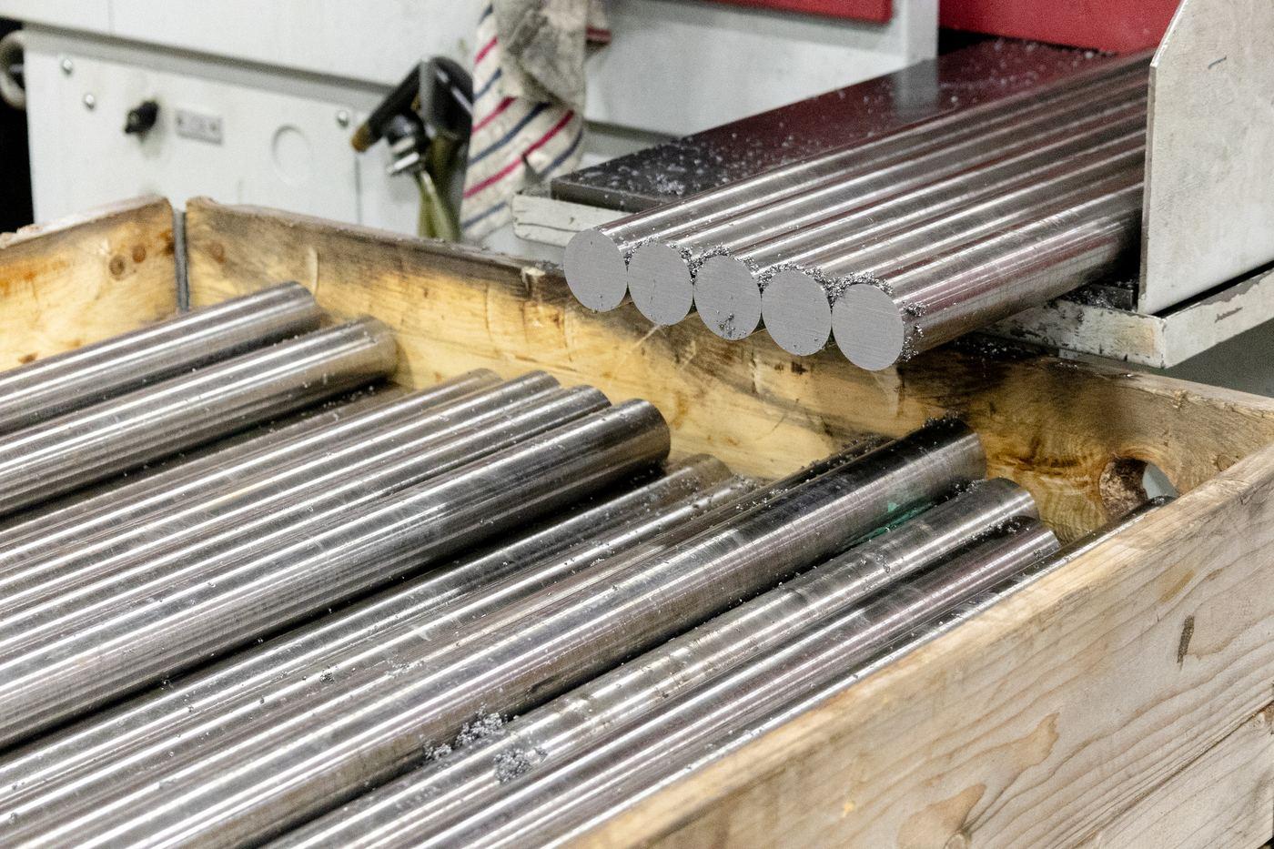 Bright engineering bar cut pieces in wooden cradle at Parkside Steel