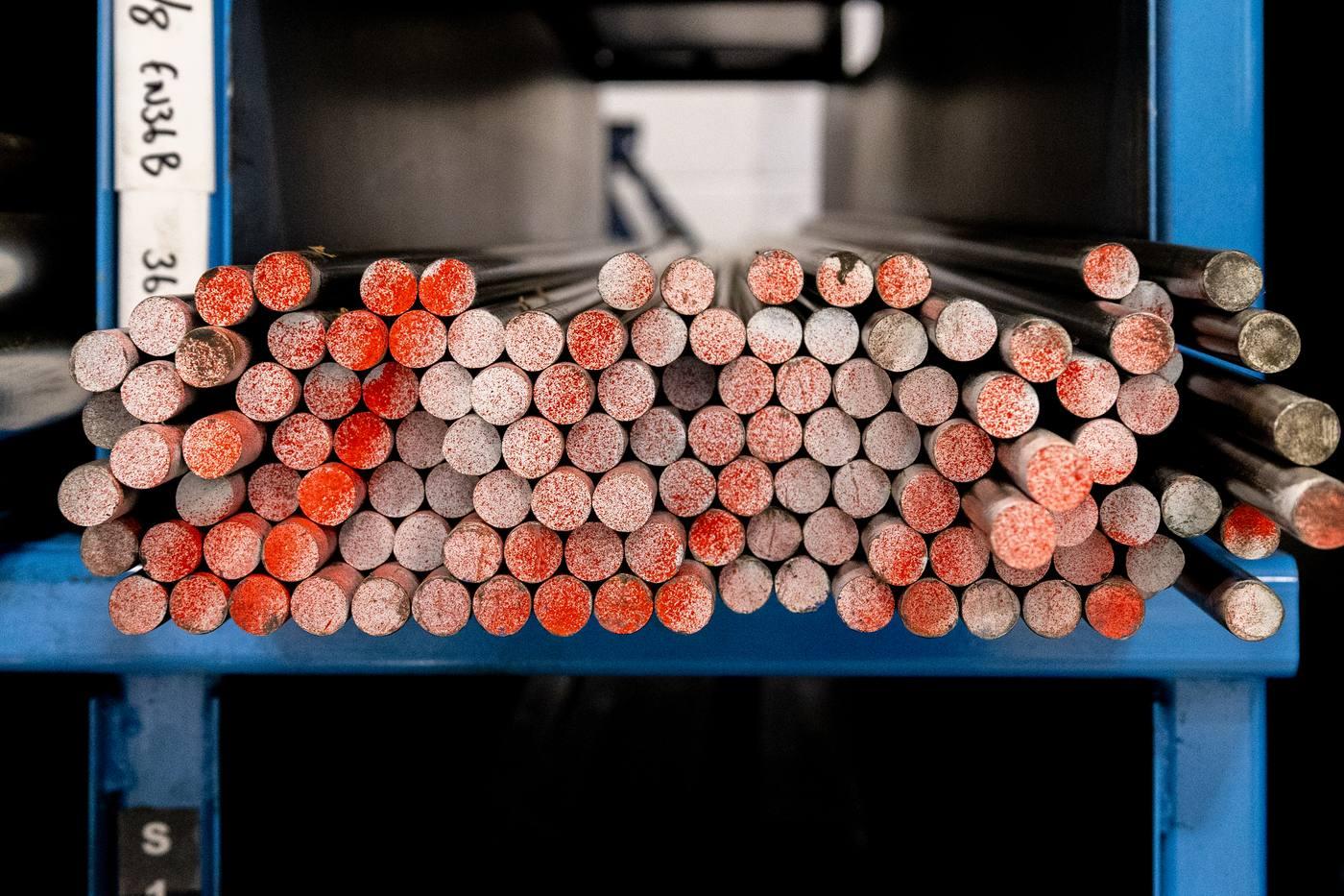 Red colour-coded alloy bar ends in blue cantilever racking — EN19 42CrMo4 grade