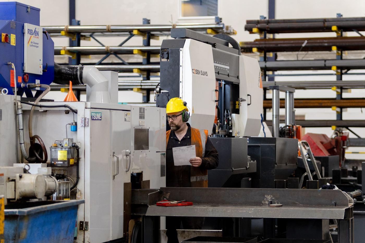 Operator reviewing job sheet between TSUNE and COSEN saws