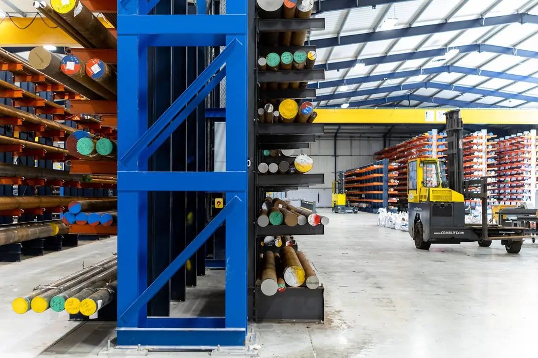Parkside Steel facility overview — blue and orange racking, Combilift, COSEN saws, overhead crane