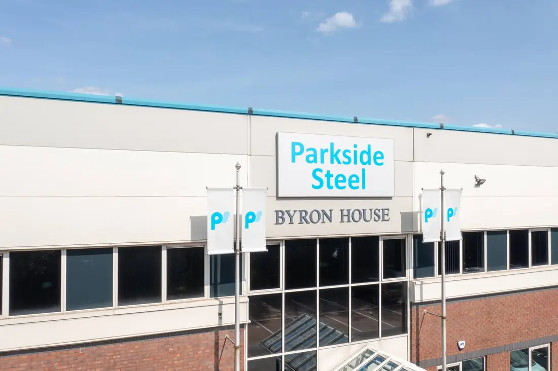 Parkside Steel Byron House entrance signage with PS logo flags and teal roof trim
