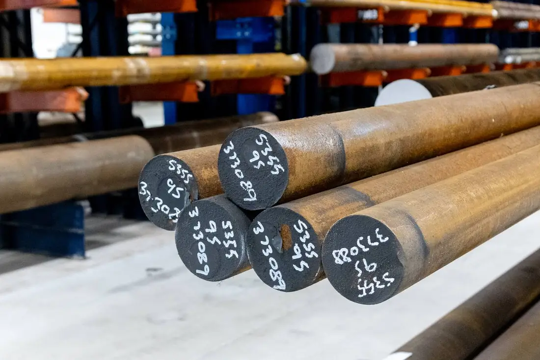 Large diameter black round bar ends with chalk grade markings — S355 grade