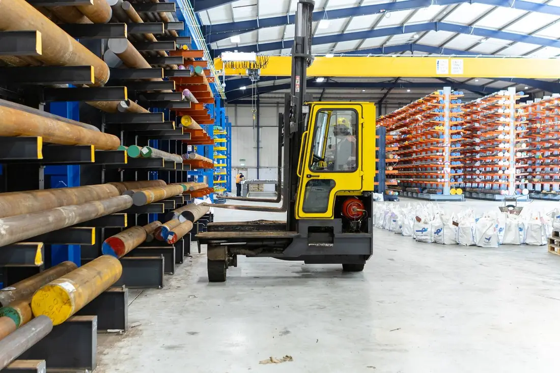 Parkside Steel warehouse — Combilift on open floor with racking, crane and branded bulk bags